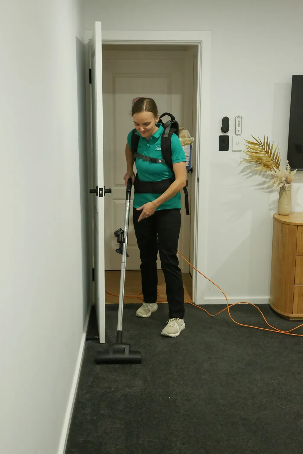 Alice vacuuming a bedroom