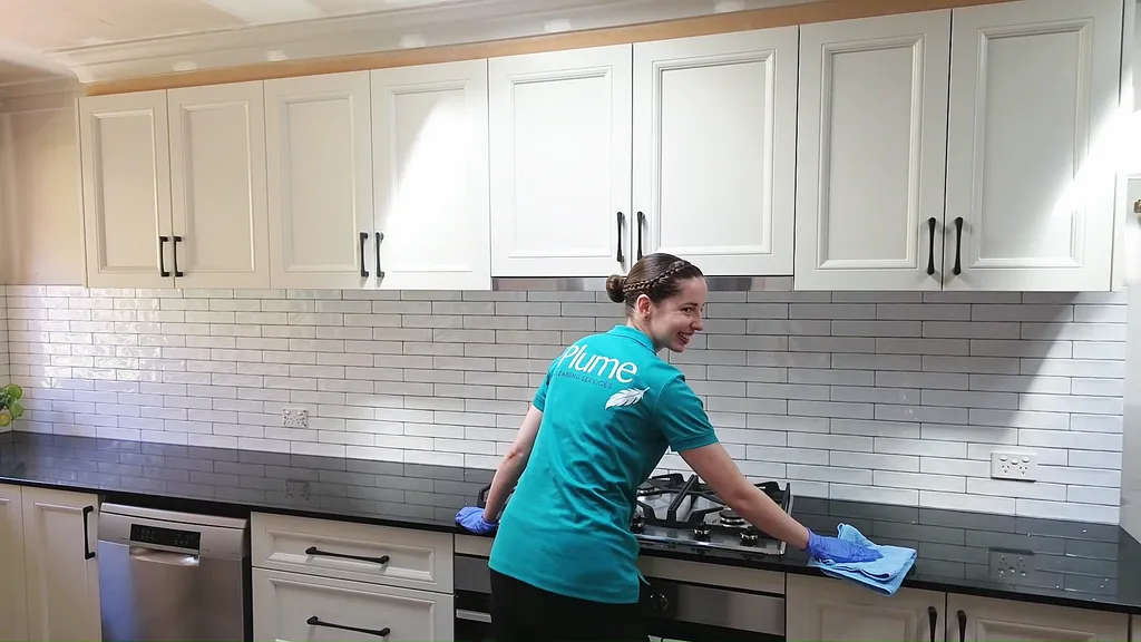 Kara cleaning a kitchen