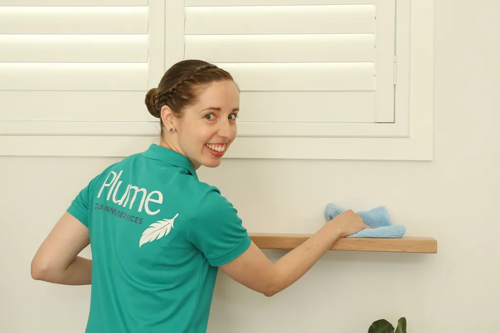 Kara cleaning a shelf
