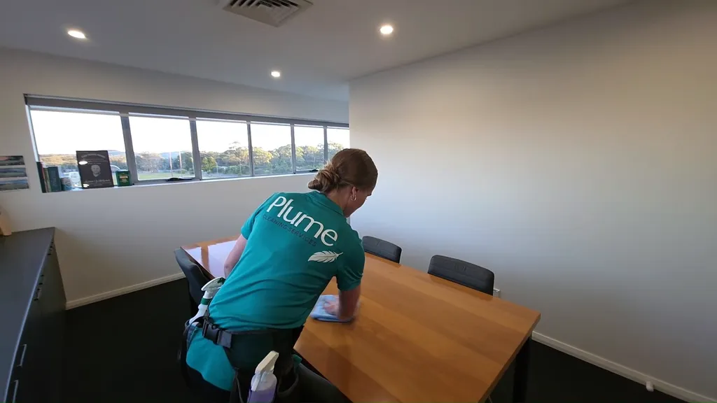 Alice cleaning a boardroom